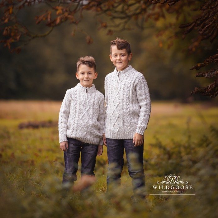 Two boys on a family photo shoot in Towcester. Wearing white jumpers and jeans