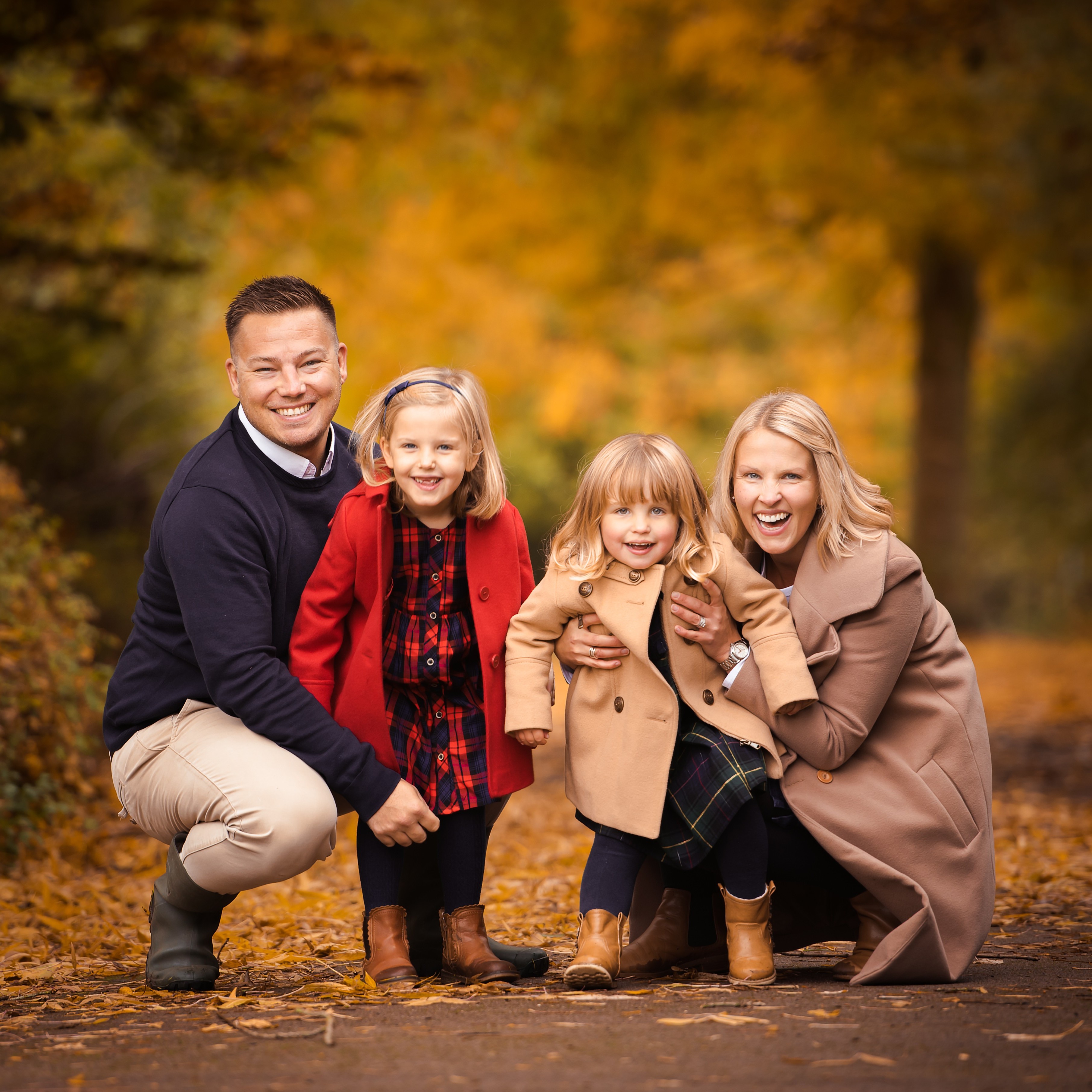 Family photo shoot in autumn with yellow leaves